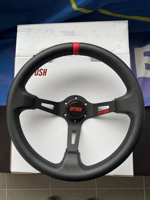 Front close-up of the black leather Avtosh three-spoke sport steering wheel with red centre marker.