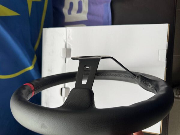 Side profile showing the depth and padded black leather rim of the Avtosh sport steering wheel.